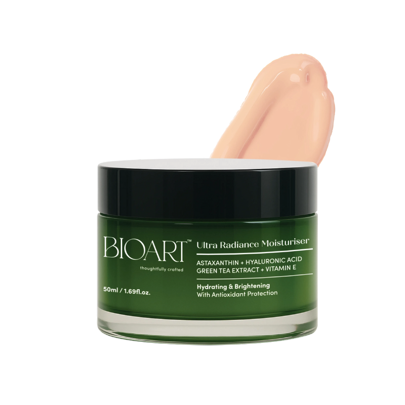 Green jar of BIOART Ultra Radiance Moisturizer with a hand applying cream on a white background