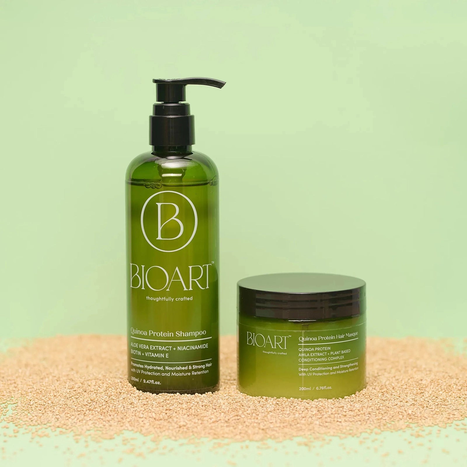 BIOART shampoo and hair mask bottles on a textured surface with a green background
