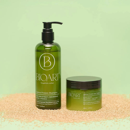 BIOART shampoo and hair mask bottles on a textured surface with a green background
