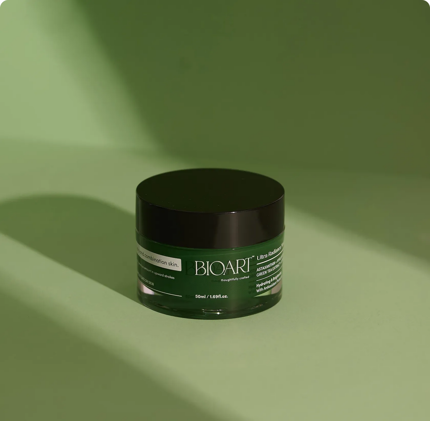 Green skincare jar with 'BIOAART' branding on a green background