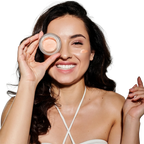 Woman applying makeup with a compact powder on a white background